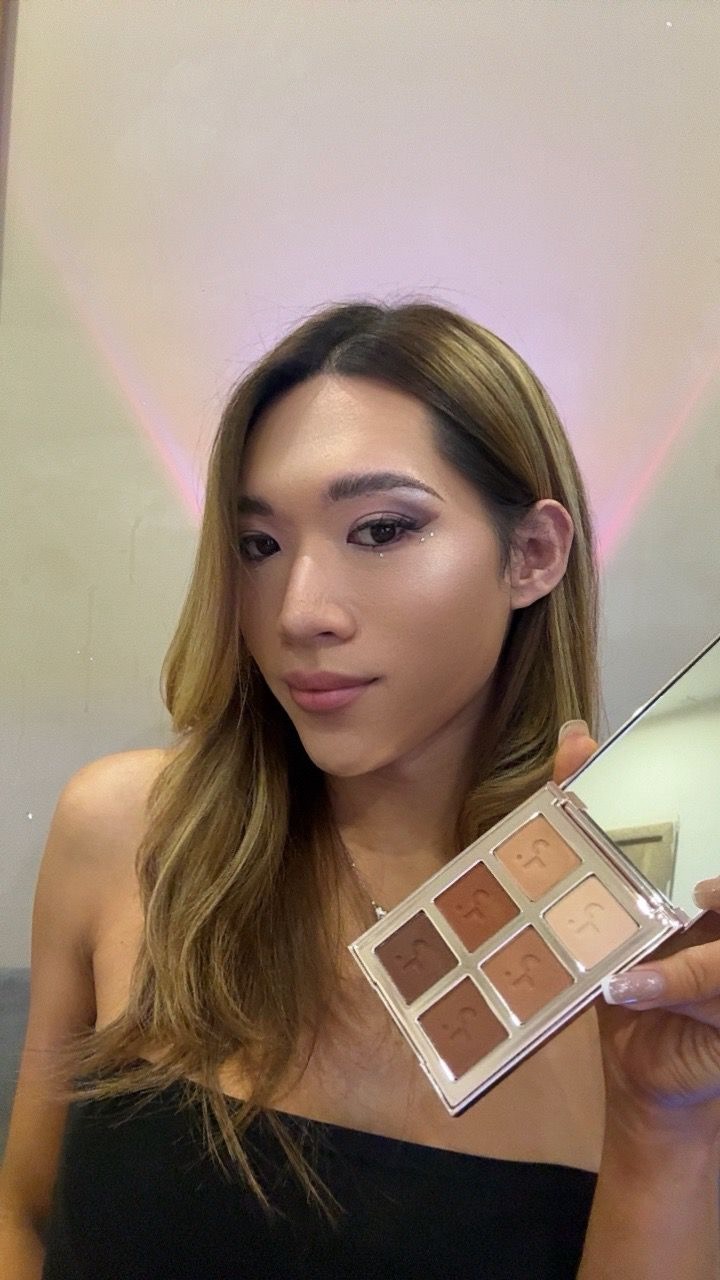 Maddie showcasing Patrick Ta eyeshadow palette with brown eye makeup